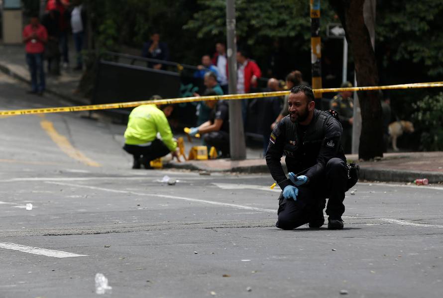 A police officer works the scene where an explosion occurred near Bogota's bullring