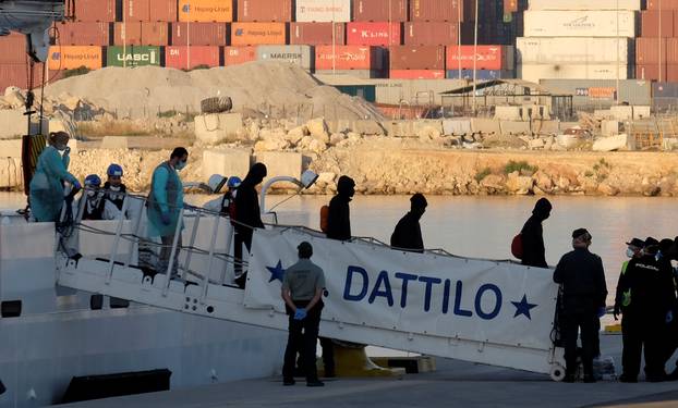 Refugees disembark the Dattilo rescue ship in the port in Valencia