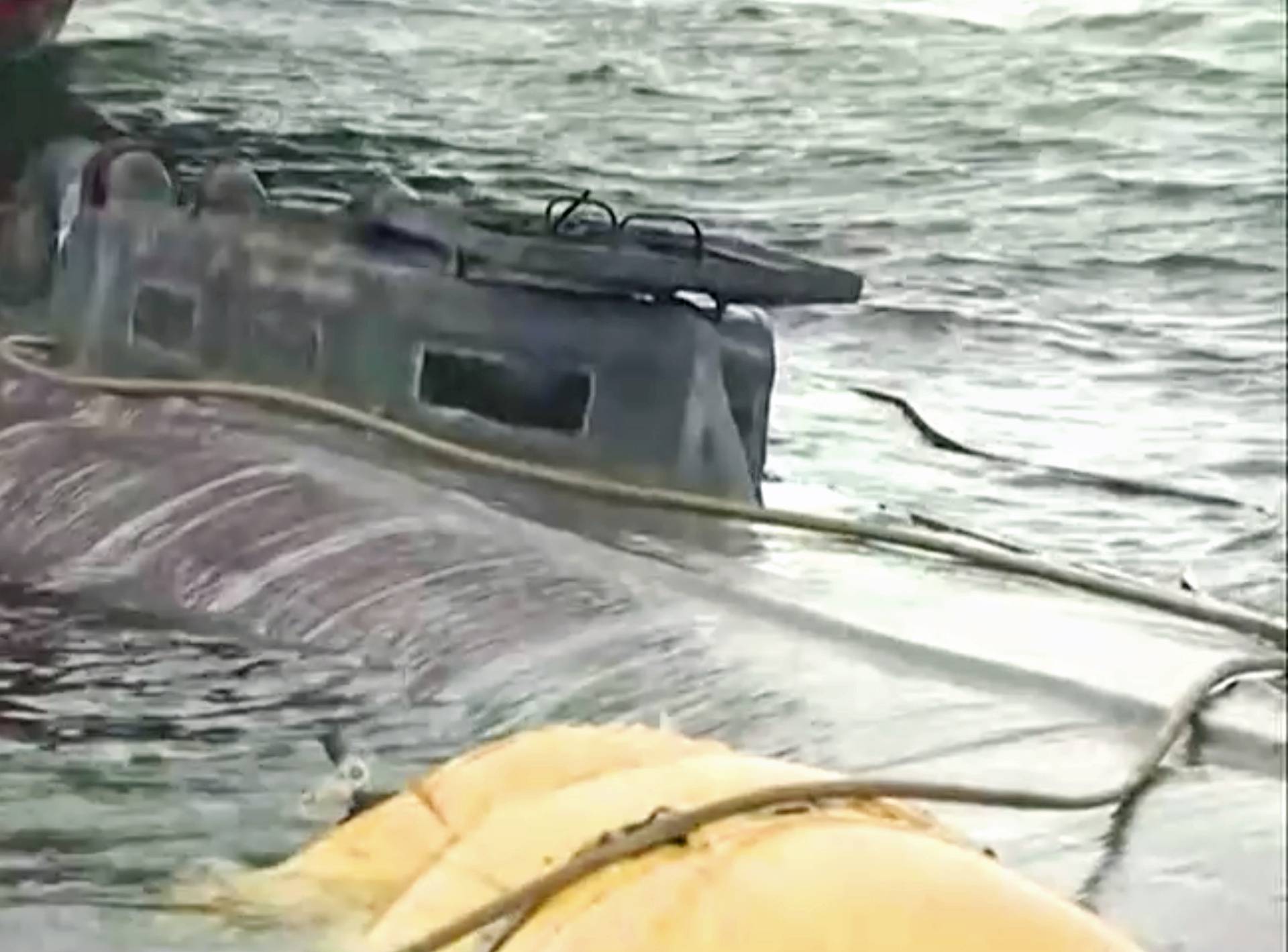 A suspected drug submarine believed to be carrying cocaine is refloated at a port in Aldan