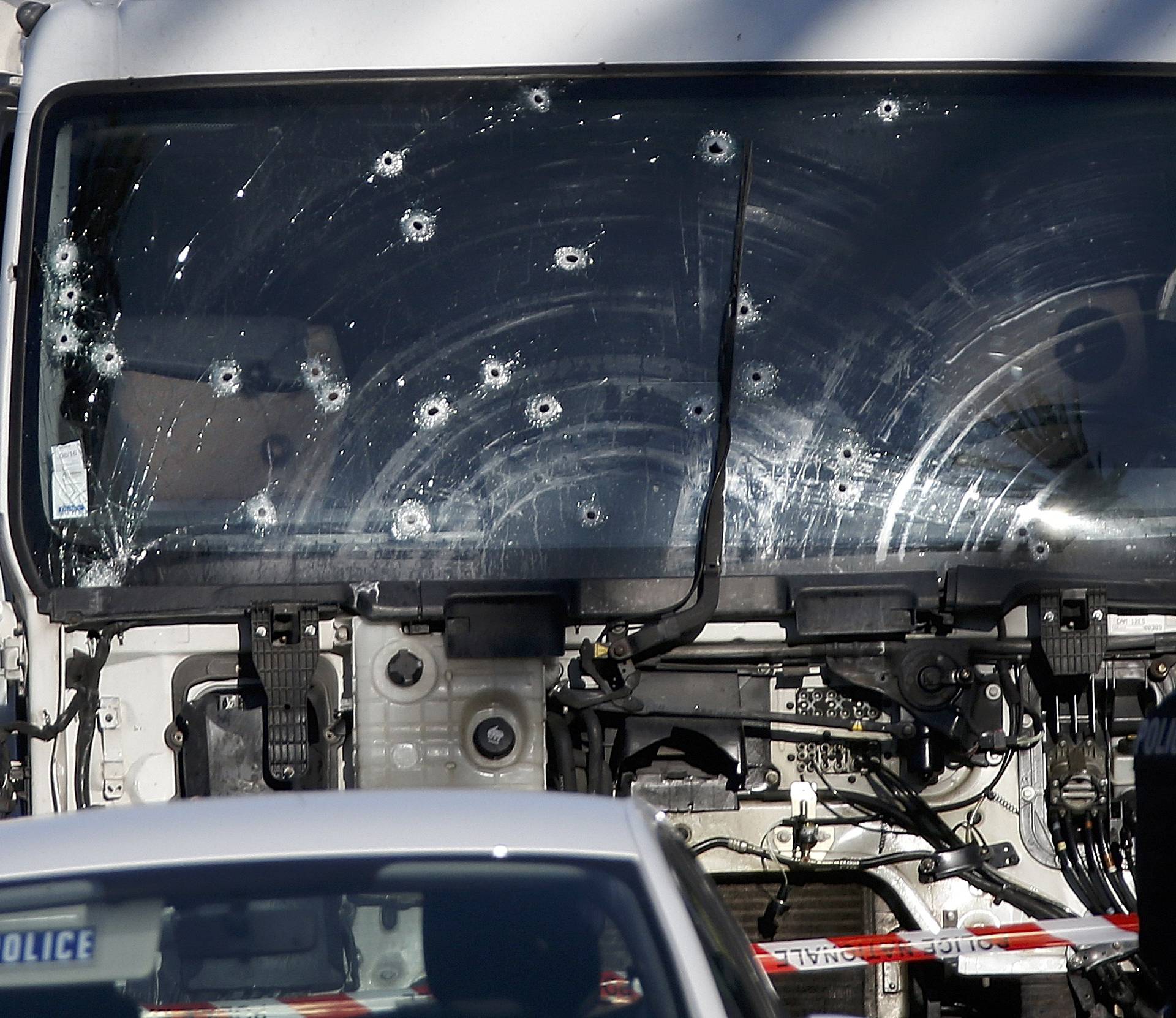 Bullet imacts are seen on the heavy truck the day after it ran into a crowd at high speed killing scores celebrating the Bastille Day July 14 national holiday on the Promenade des Anglais in Nice