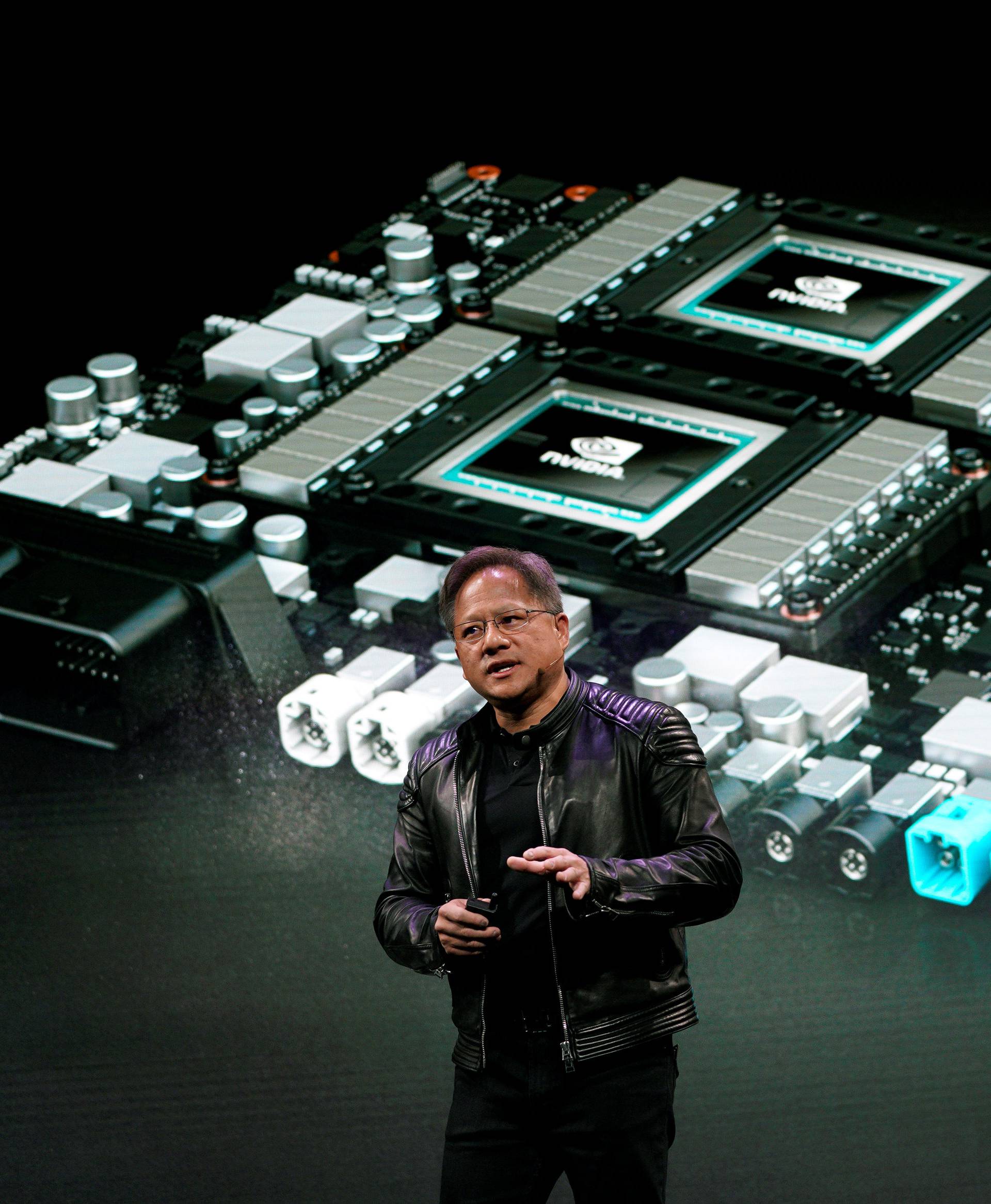 Jensen Huang, CEO of Nvidia, shows the Drive Pegasus robotaxi AI computer at his keynote address at CES in Las Vegas