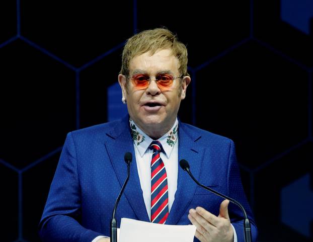 Singer Elton John speaks after receiving a Crystal Award from Hilde Schwab, Chairperson and Co-Founder, Schwab Foundation for Social Entrepreneurship, during the World Economic Forum (WEF) annual meeting in Davos