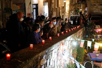 People gather to mourn the death of Argentine soccer legend Diego Maradona, in Naples