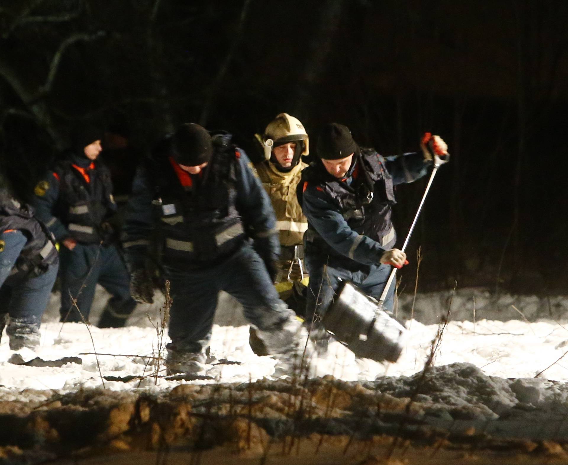 Emergency services work at the scene where a Saratov Airlines Antonov AN-148 plane crashed after taking off from Moscow's Domodedovo airport, outside Moscow