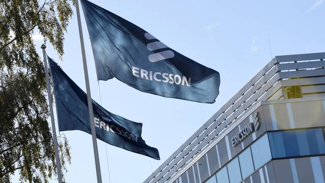 FILE PHOTO: Flags with Ericsson logo are pictured outside company's head office in Stockholm