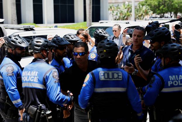 Police officers gather near the Wilkie D. Ferguson Jr. United States Courthouse, in Miami