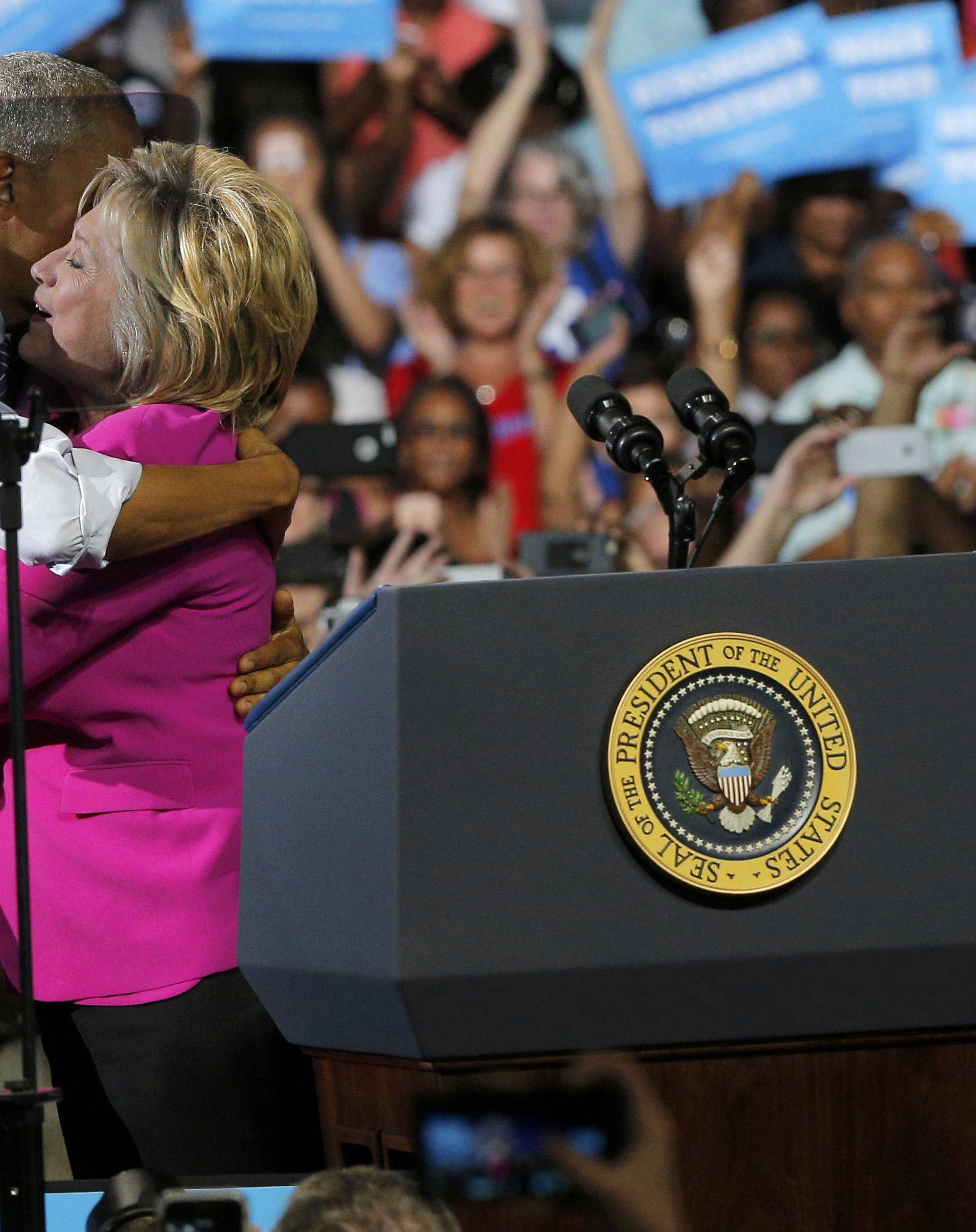 U.S. President Obama embraces Democratic U.S. presidential candidate Clinton at campaign event in Charlotte, North Carolina