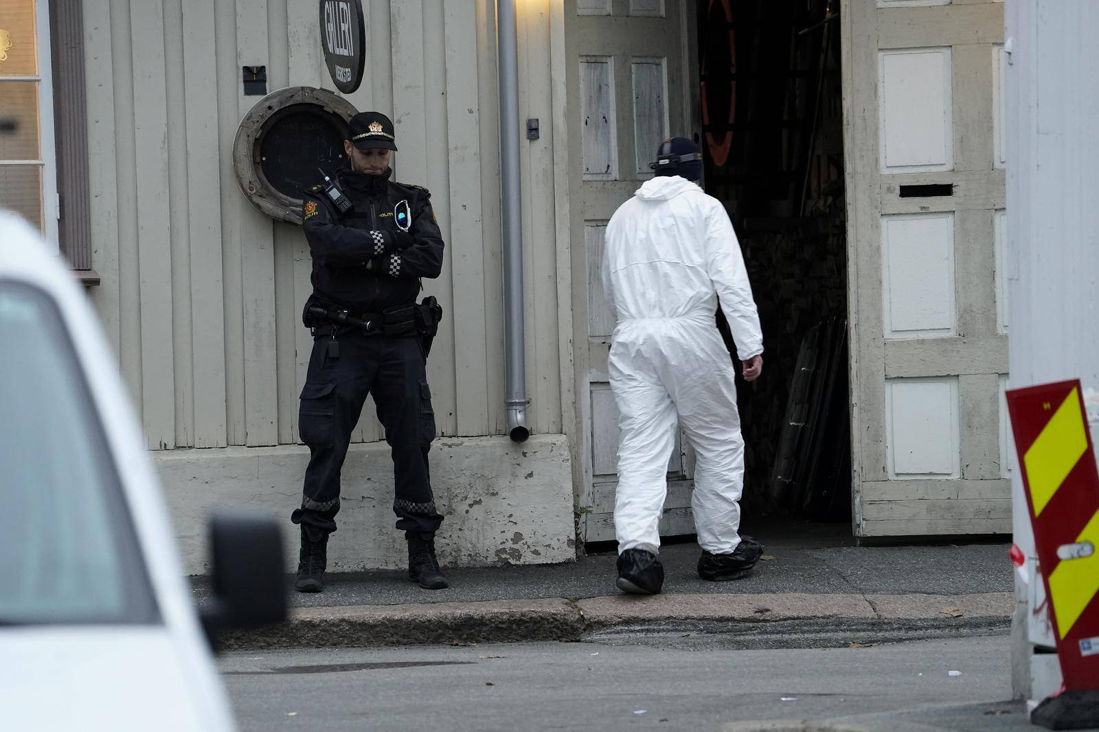 A police technician enters a building after a deadly attack in Kongsberg