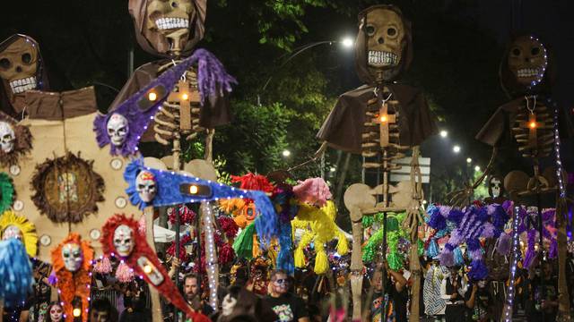 Participants take part in a parade ahead of the Day of the Dead celebrations, in Mexico City