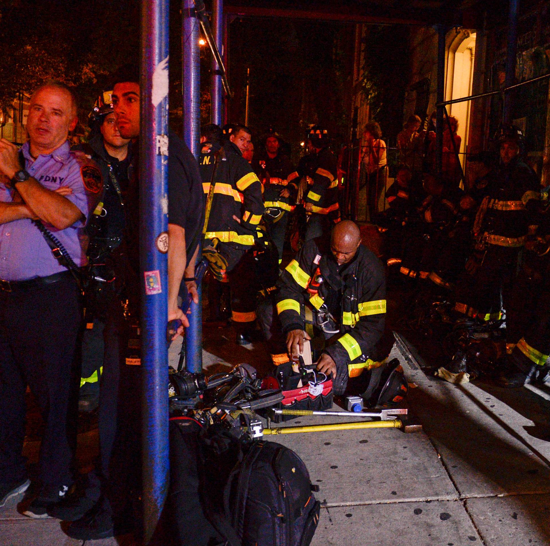 New York City firefighters stand near site of explosion in New York