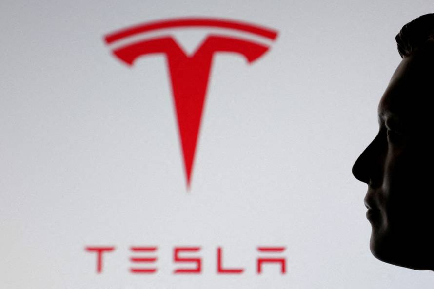 FILE PHOTO: Illustration shows 3D printed miniature model of Elon Musk and Tesla logo