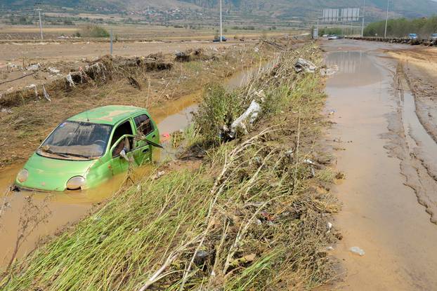 A wrecked car is seen after heavy floods in Cento 