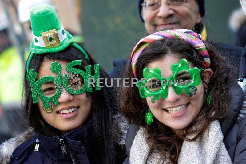 FILE PHOTO: Paradegoers watch the St Patrick's Day parade in New York City