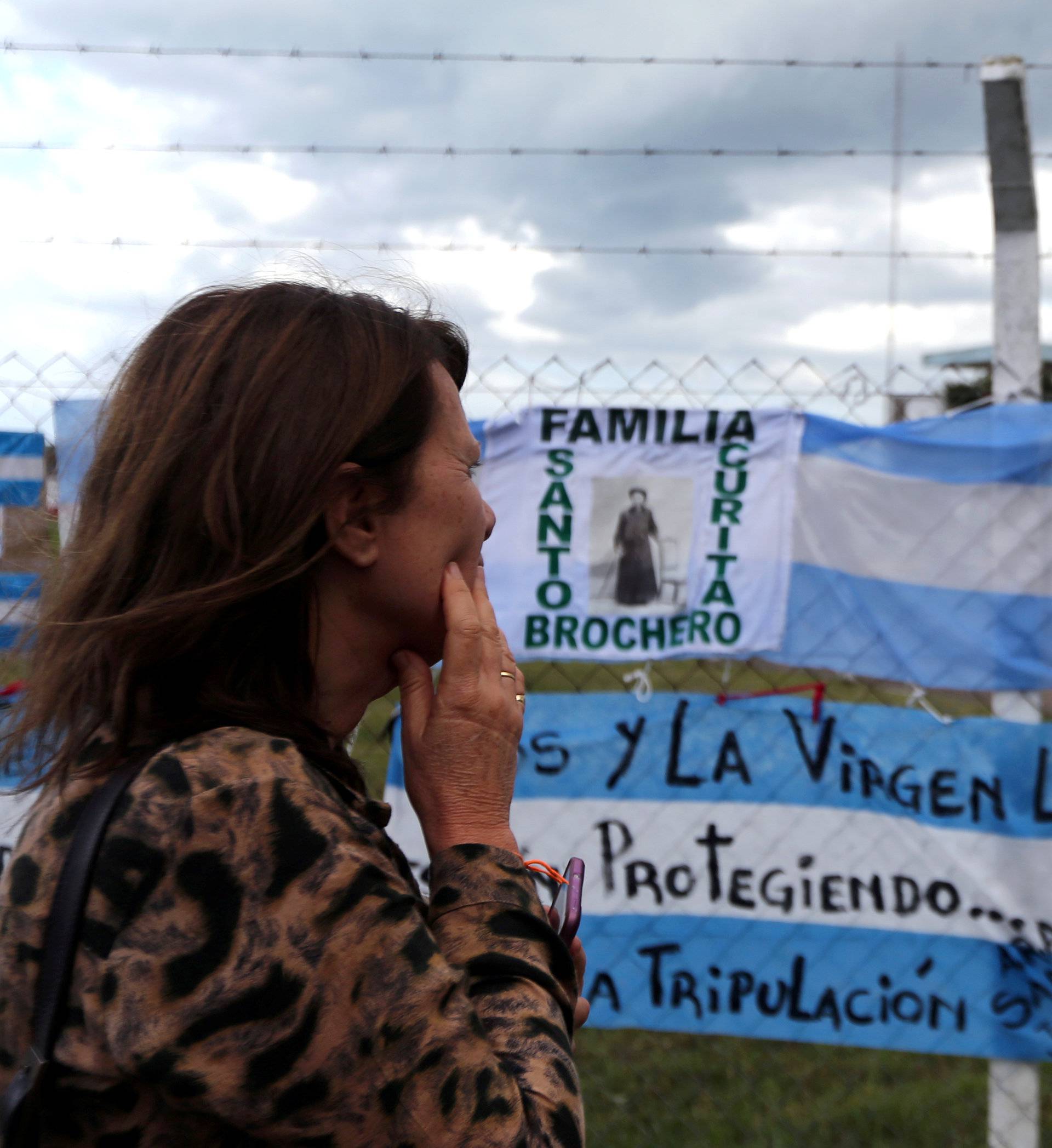 A woman looks at signs in support of the missing crew members of the ARA San Juan submarine in Mar del Plata
