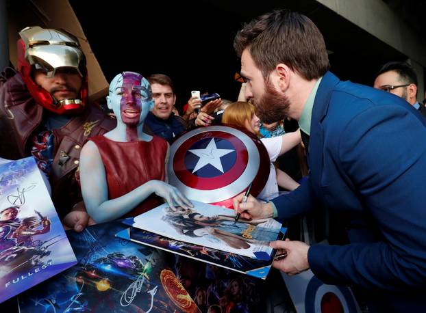 Cast member Chris Evans signs autographs for fans on the red carpet at the world premiere of the film "The Avengers: Endgame" in Los Angeles