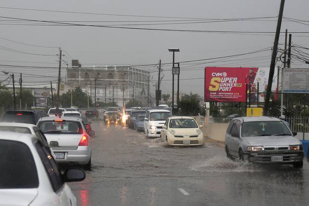 Traffic moves slowly as heavy rains caused by the outer rain bands of Hurricane Matthew move into Kingston