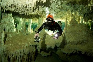 Scuba diver measures the length of Sac Aktun underwater cave system as part of the Gran Acuifero Maya Project near Tulum