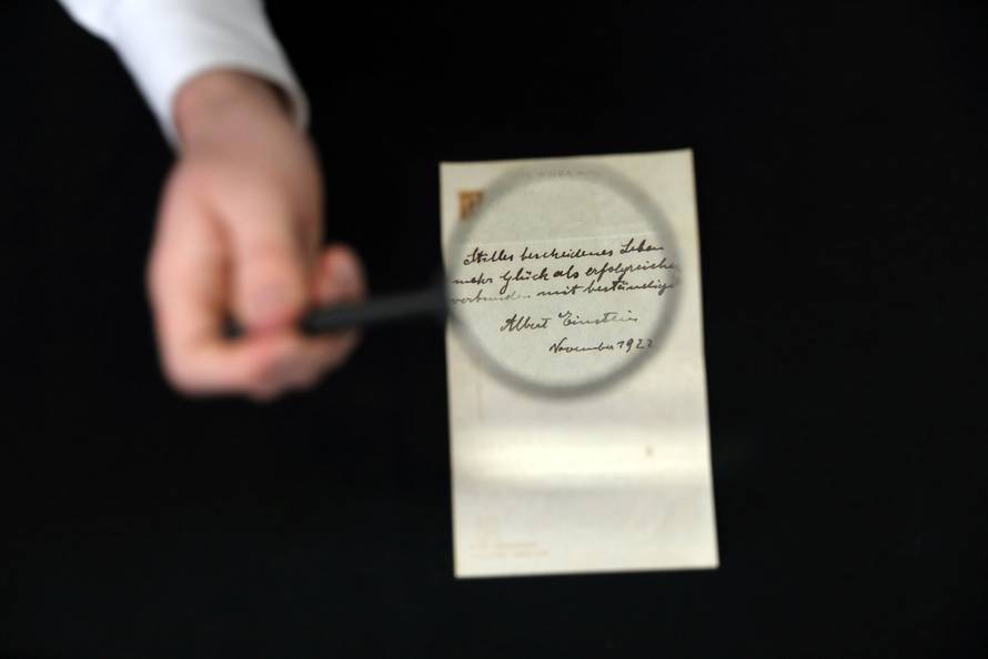 A note written on a Tokyo hotel official paper in 1922 by Albert Einstein is seen before it is sold at an auction in Jerusalem