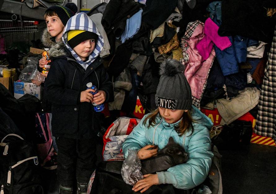 Children rest at a collecting point after fleeing from Mariupol to Zaporizhzhia