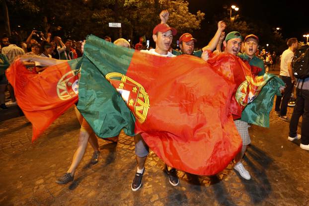 Portugal fans react on the Champs-Elysees after their team won the EURO 2016 final soccer match       