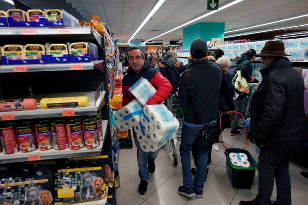 Shoppers buy provisions in a supermarket in Bilbao