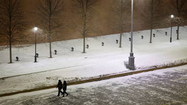 Law enforcement officers walk along the Kremlin wall during New Year's Eve celebrations in Moscow