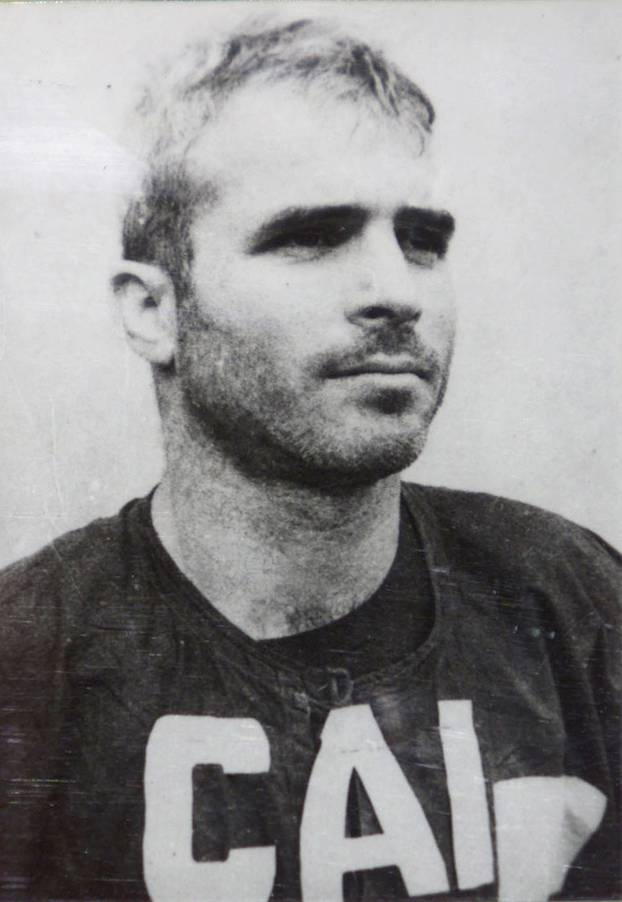 FILE PHOTO -  A black and white photograph taken in 1967 of then captured navy pilot John McCain is shown as part of an exhibit on American prisoners of war in Hanoi