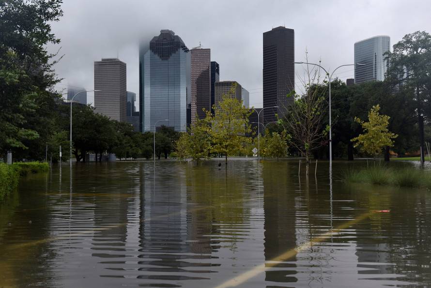 The downtown skyline is reflected in the flood water at Buffalo Bayou Park after Hurricane Harvey inundated the Texas Gulf coast with rain causing widespread flooding, in Houston, Texas