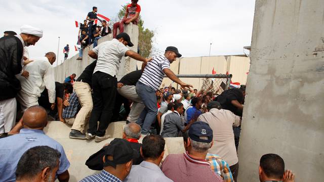 Followers of Iraq's Shi'ite cleric Moqtada al-Sadr are seen in the parliament building as they storm Baghdad's Green Zone after lawmakers failed to convene for a vote on overhauling the government, in Iraq