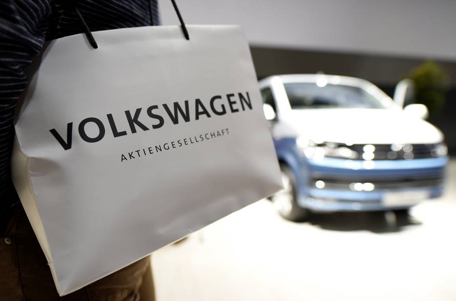 A Volkswagen shareholder carries a bag at the annual shareholder meeting in Hanover