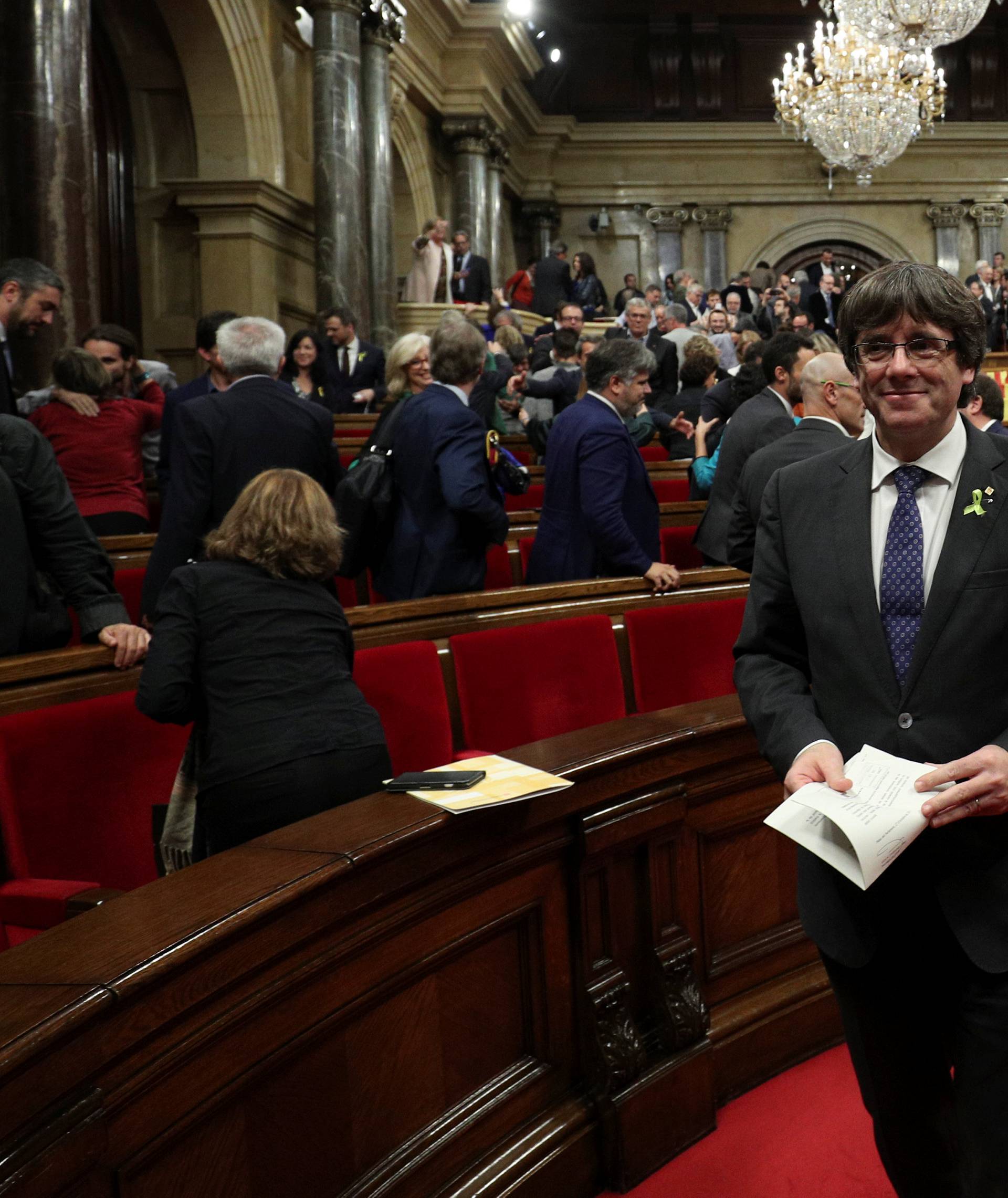 Catalan President Carles Puigdemont smiles after the Catalan regional Parliament declared independence from Spain in Barcelona