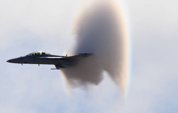 F-18 Super Hornet supersonic jet creates conical vapour trail as it breaks sound barrier, San Diego, California, America - 21 Jan 2011