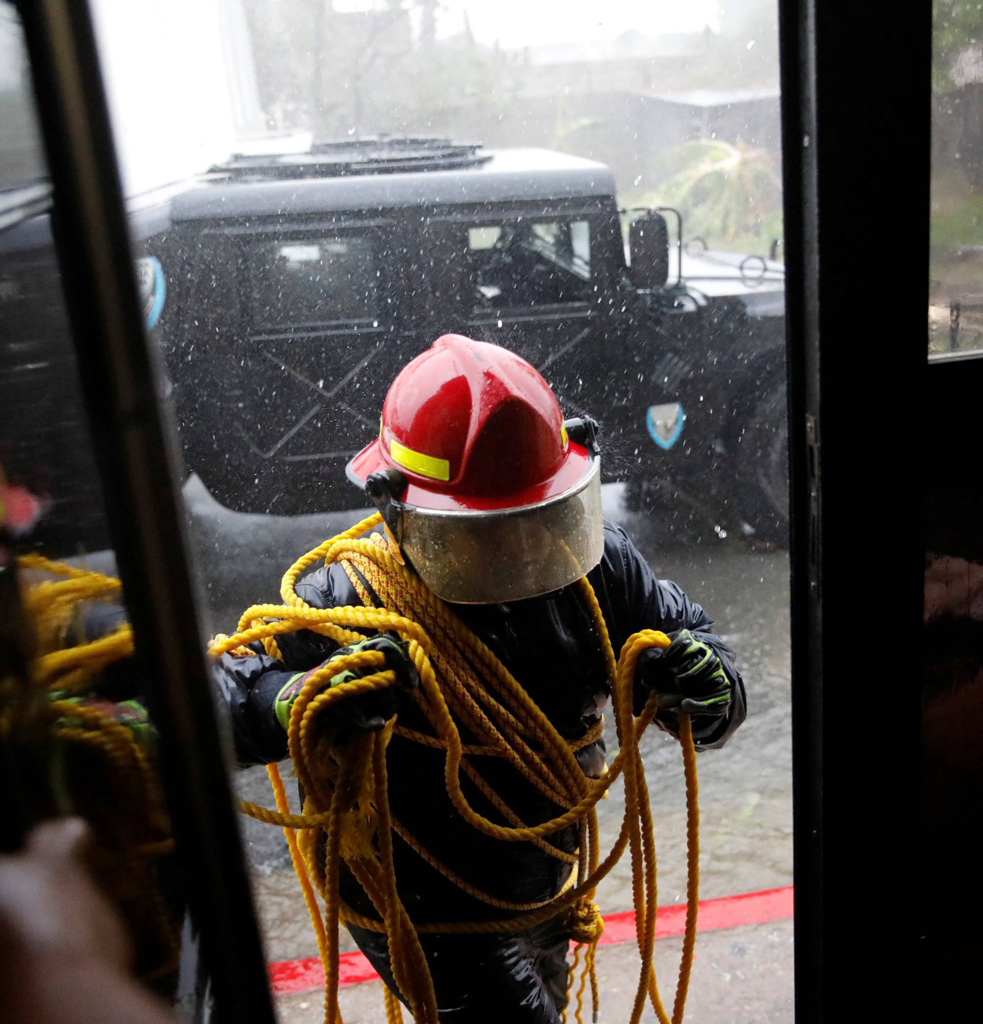 A rescue worker enters in to the Emergency Operation Centre after the area was hit by Hurricane Maria in Guayama