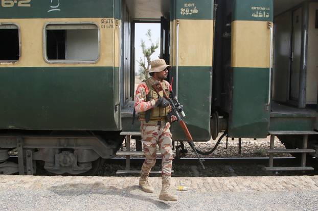 A Pakistan Army soldier stands guard next to a rescue train, after the attack on a train by separatist militants in Bolan, at the railway station in Mushkaf
