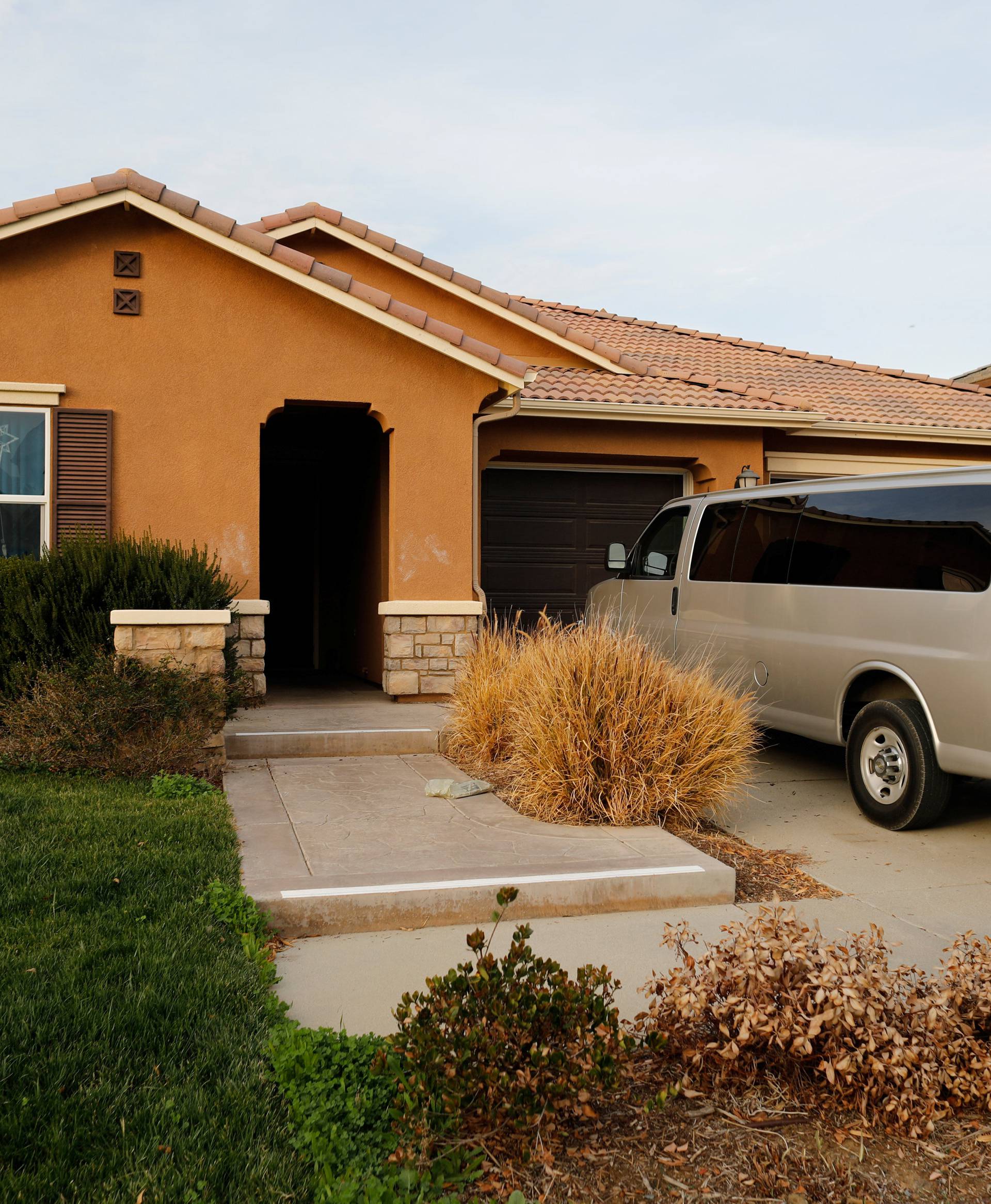 A van sits parked on the driveway of the home of the Turpins in Perris