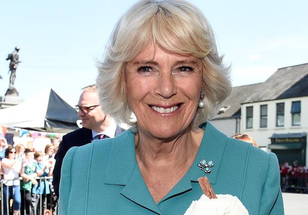 Britain's Camilla Duchess of Cornwall enjoys an ice cream during a visit to Dromore Village in County Down, Northen Ireland