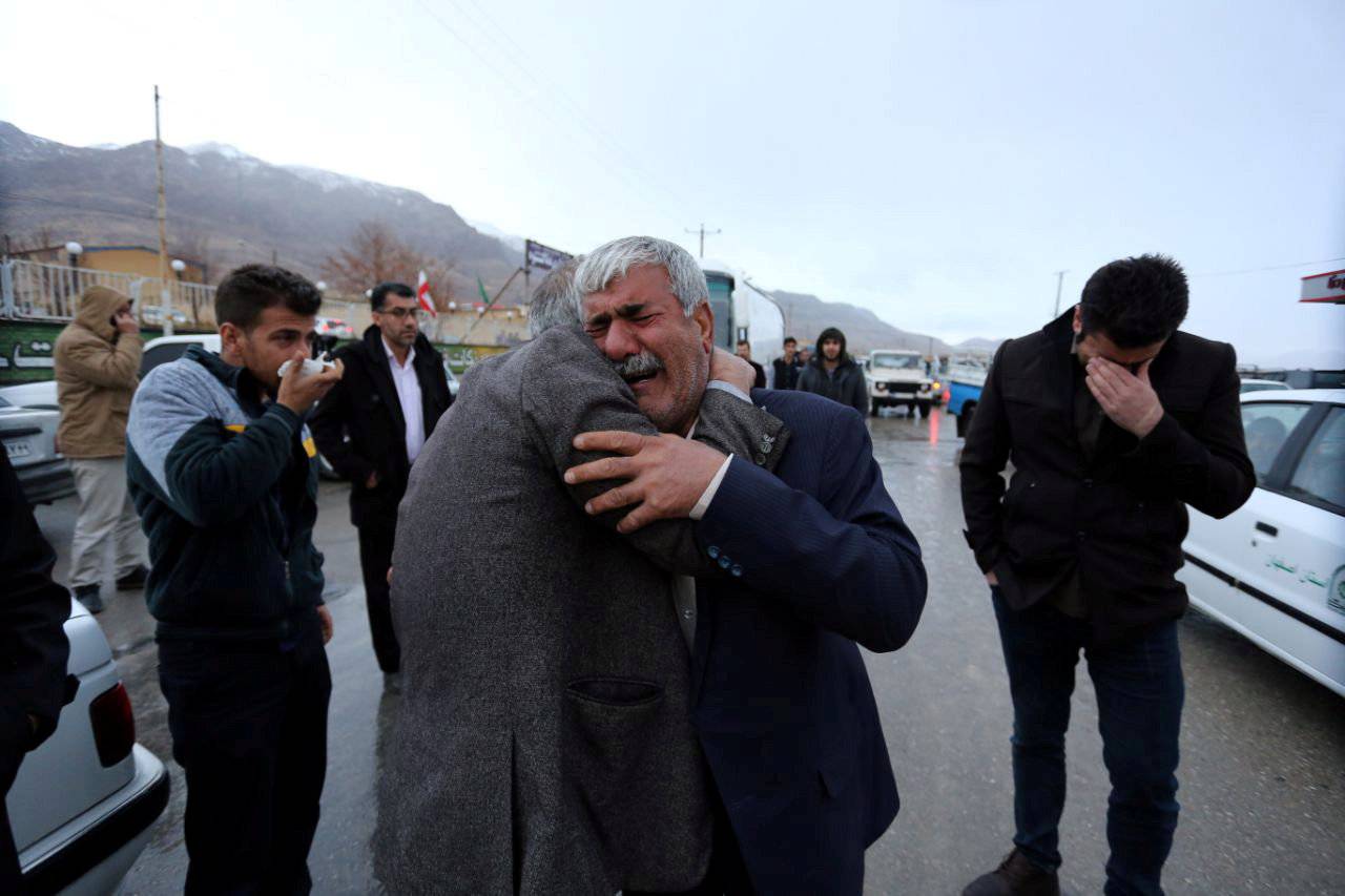 Relative of a passenger who was believed to have been killed in a plane crash reacts near the town of Semirom
