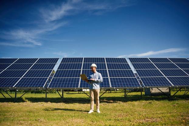 Sunny,Daytime.,Engineer,With,Photovoltaic,Solar,Panels,Outdoors.