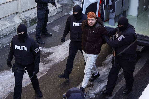 Mohamed Amra is escorted inside the Bucharest Court of Appeal