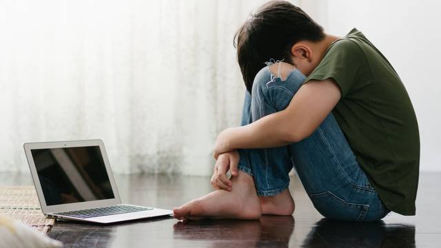 Cyberbullying,And,Depression.,Asian,Teenage,Boy,Sitting,Alone,And,Hugging