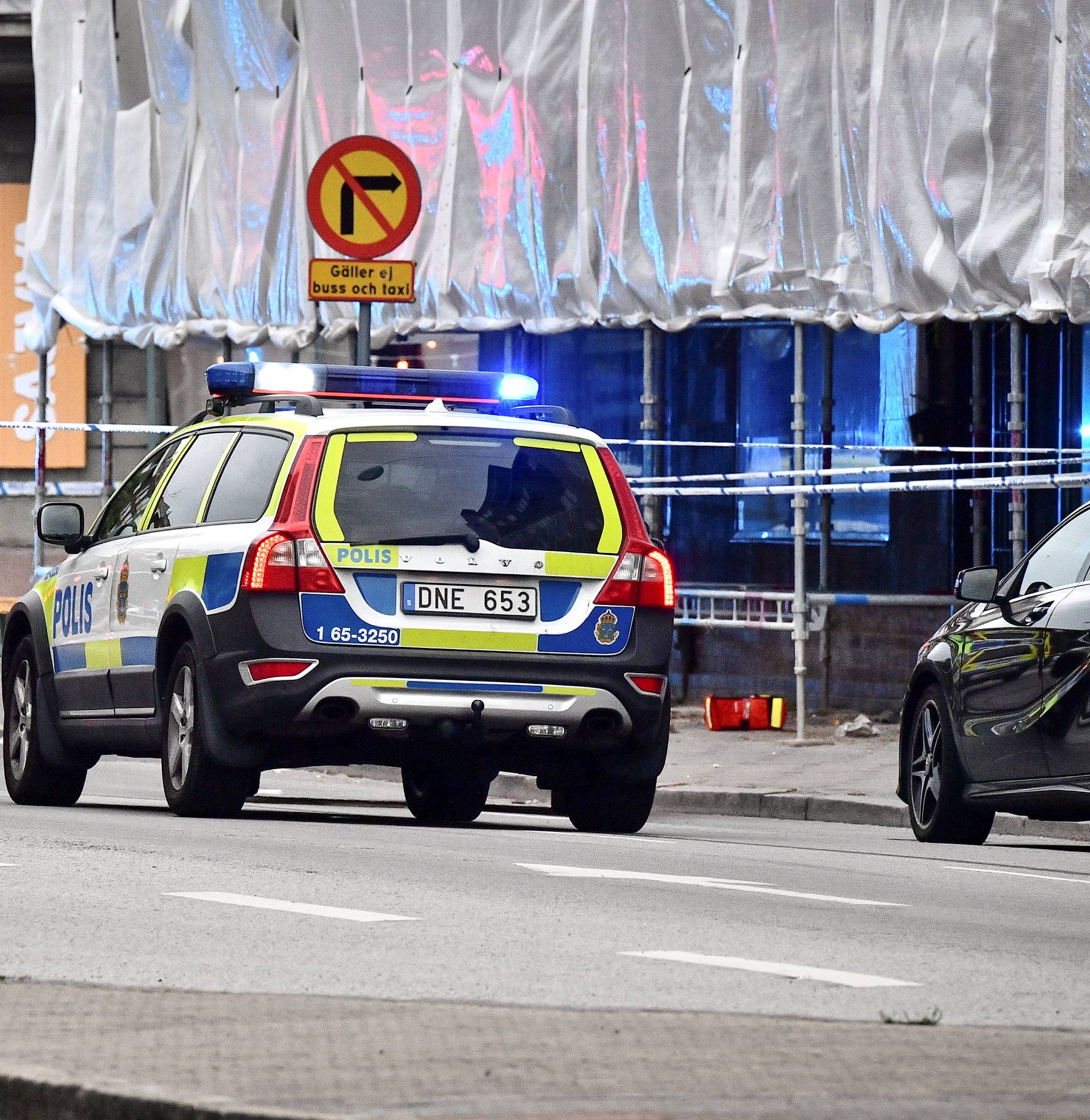 Police stand next to a cordon after a shooting on a street in central Malmo