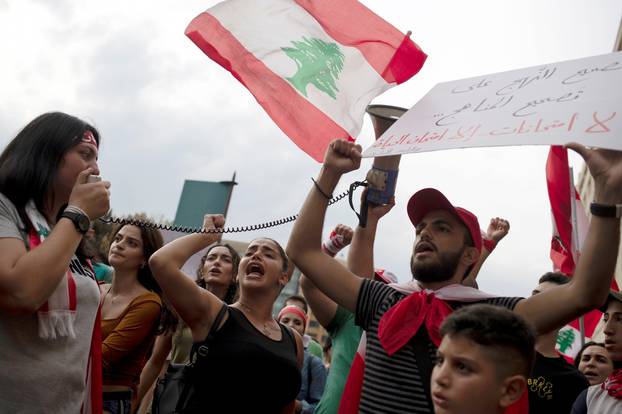Demonstrators shout slogans during ongoing anti-government protests in downtown Beirut