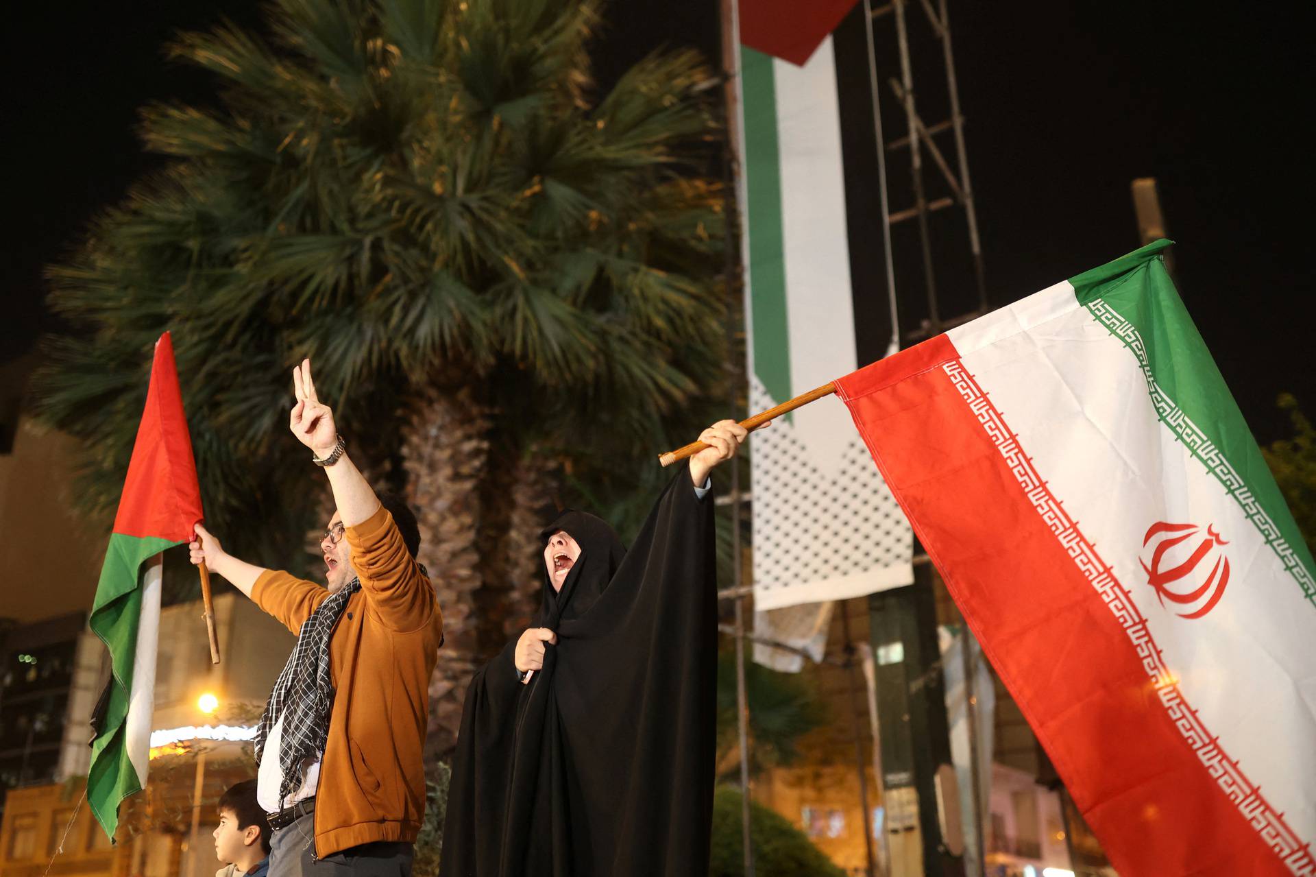 Iranians celebrate on a street, after the IRGC attack on Israel, in Tehran