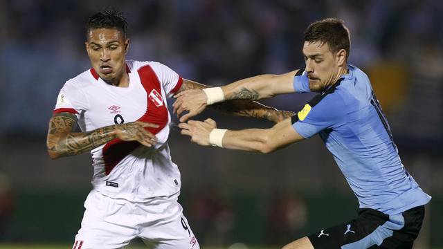 FILE PHOTO: Football Soccer - Uruguay v Peru - World Cup Qualifiers - Centenario stadium - Montevideo, Uruguay. 29/3/16. Uruguay's Sebastian Coates and Alvaro Gonzalez and Peru's Paolo Guerrero