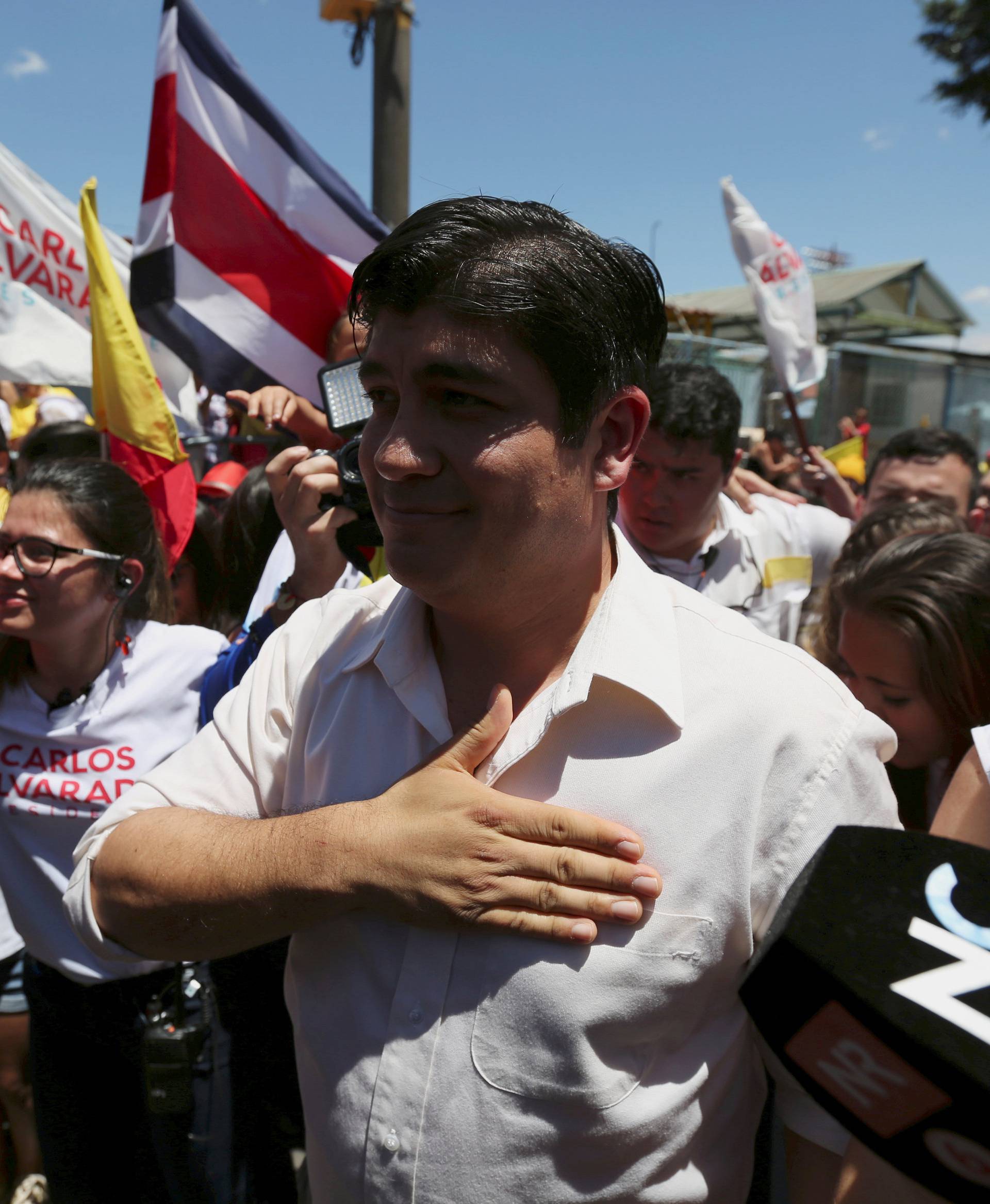 Carlos Alvarado Quesada, presidential candidate of the ruling Citizens' Action Party, gestures to supporters after casting his ballot during the presidential election in San Jose