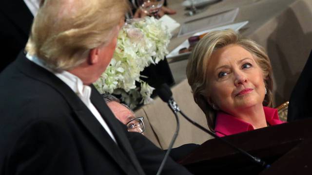 Democratic U.S. presidential nominee Hillary Clinton looks at Republican U.S. presidential nominee Donald Trump as he speaks during the Alfred E. Smith Memorial Foundation dinner in New York, U.S.