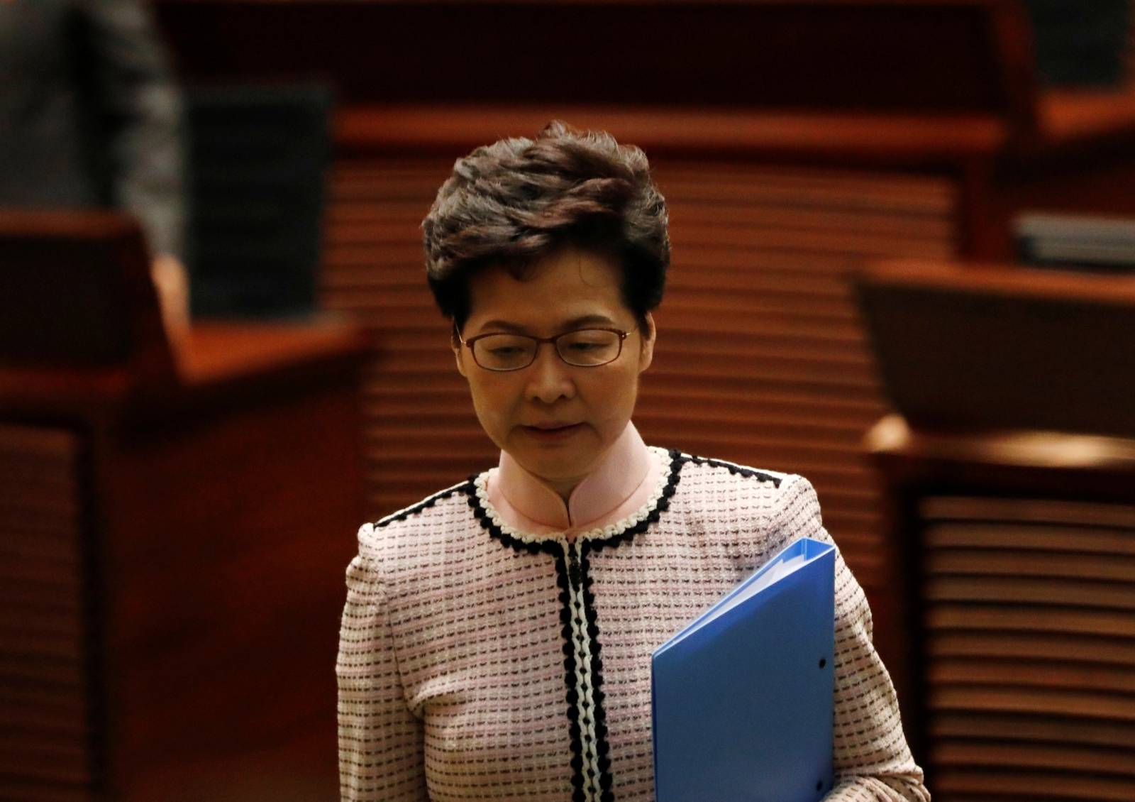 Hong Kong Chief Executive Carrie Lam reacts as lawmakers shout slogans, disrupting her annual policy address at the Legislative Council in Hong Kong