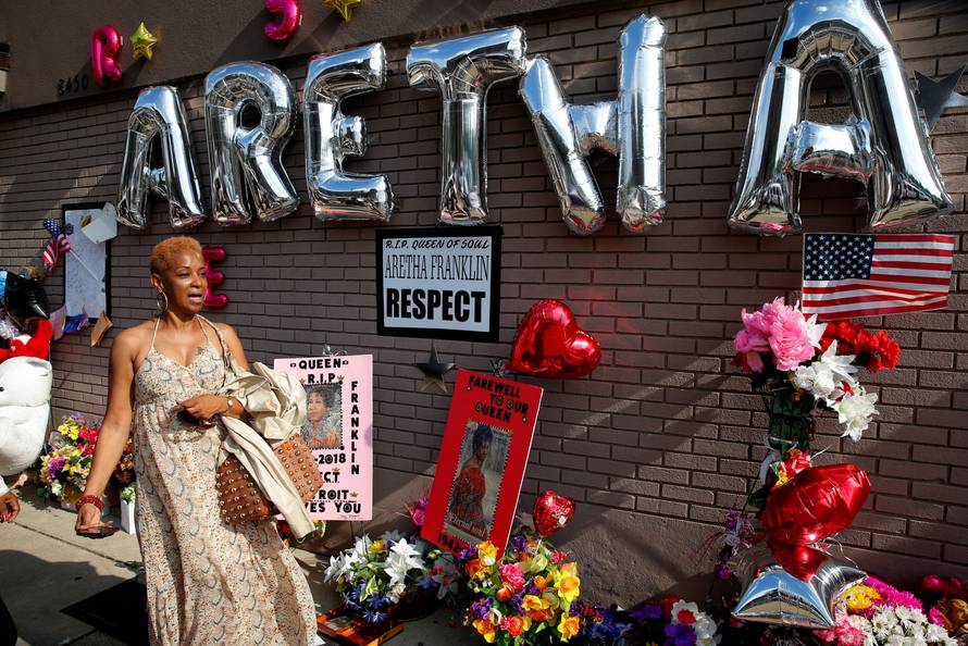 A woman stands by a makeshift memorial outside the New Bethel Baptist Church before a gospel tribute concert to late singer Aretha Franklin at in Detroit
