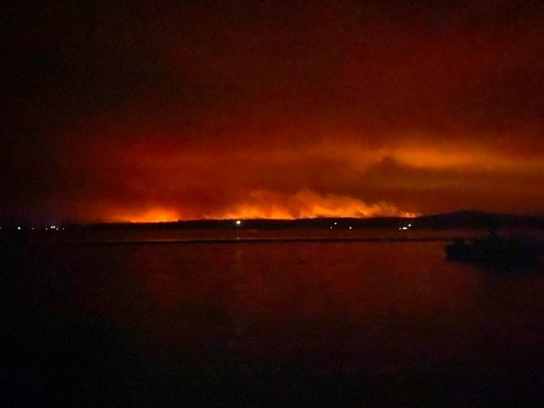 A view shows light and smoke from wild bushfires in Mallacoota