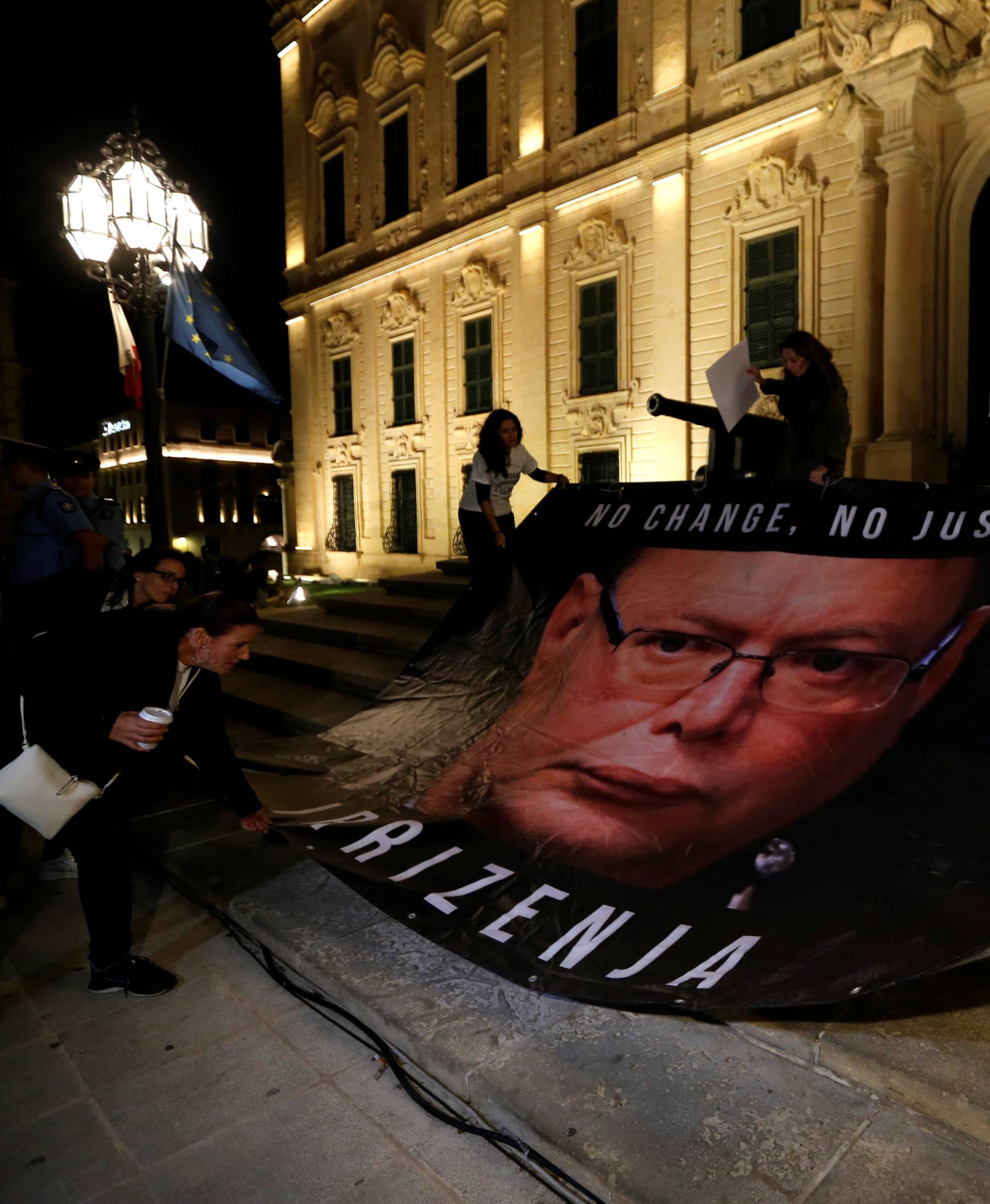 Protestors lay down a banner calling on Malta Police Commissioner Cutajar to resign on the steps of the Auberge de Castille, at the start of a four-day protest against the assassination of investigative journalist Daphne Caruana Galizia, in Valletta